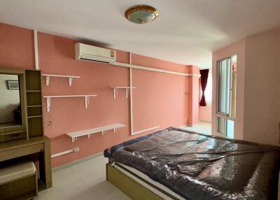 Bedroom with shelves and an air conditioner