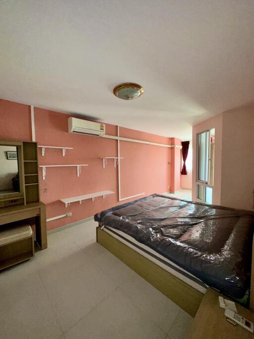 Bedroom with shelves and an air conditioner