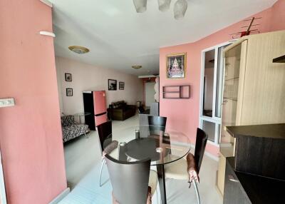 Dining area with glass table and adjacent living space