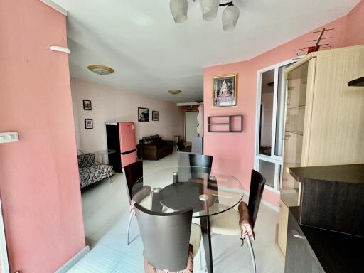 Dining area with glass table and adjacent living space