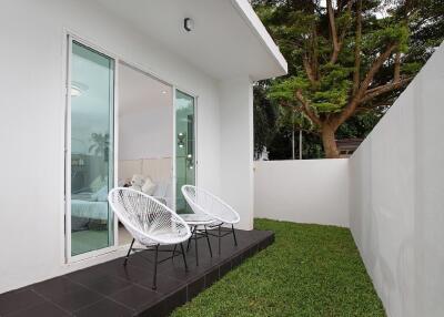 Outdoor patio with sliding glass doors and chairs