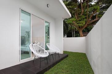 Outdoor patio with sliding glass doors and chairs