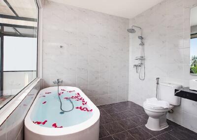 Spacious bathroom with bathtub and shower