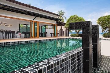 Outdoor pool with modern design and adjacent dining area