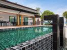 Outdoor pool with modern design and adjacent dining area