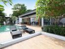 Outdoor seating area next to a swimming pool with greenery