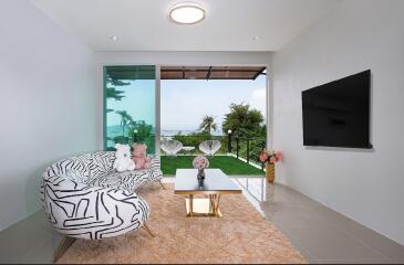 Modern living room with large window and a view, featuring unique patterned couch, coffee table, and wall-mounted TV