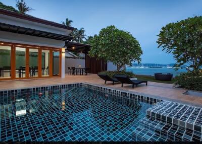 Outdoor pool area with view of the sea