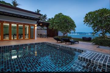 Outdoor pool area with view of the sea