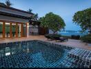 Outdoor pool area with view of the sea