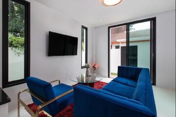 Modern living room with blue furniture and large windows