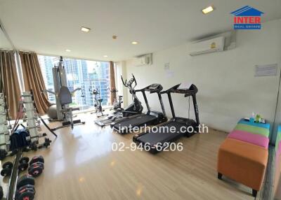 Apartment gym with equipment and city view