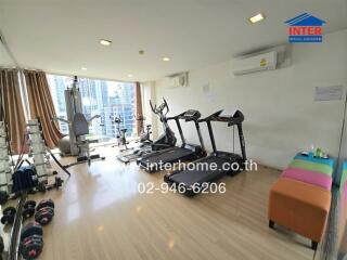 Apartment gym with equipment and city view