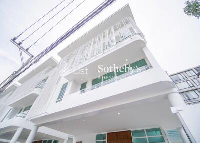 Exterior view of a modern multi-story building with white facade