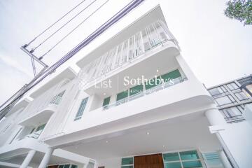 Exterior view of a modern multi-story building with white facade