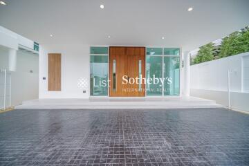 Modern building entrance with glass doors and tiled flooring