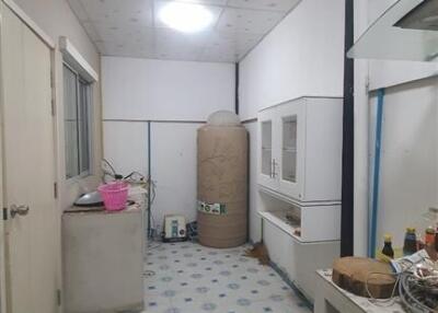 Utility room with storage tank and various items