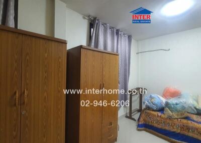 Bedroom with wooden wardrobes and bedding