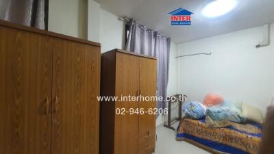 Bedroom with wooden wardrobes and bedding