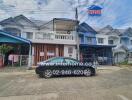 Front view of residential townhouses with a black car parked in front