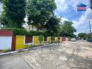 Exterior view of a residential building with colorful walls and lush greenery