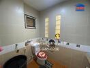 Bathroom with beige tiles, toilet, and basin