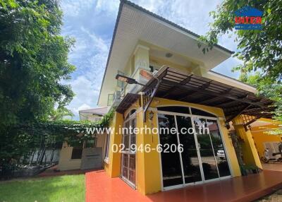 Exterior view of a residential building with a yard