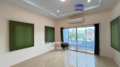 Bright living room with large windows and tile flooring