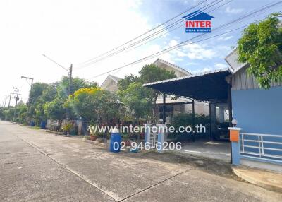 Street view of residential buildings with front gardens