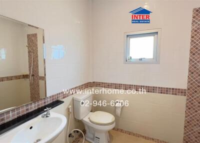 Modern bathroom with a small window, sink, toilet, and shower