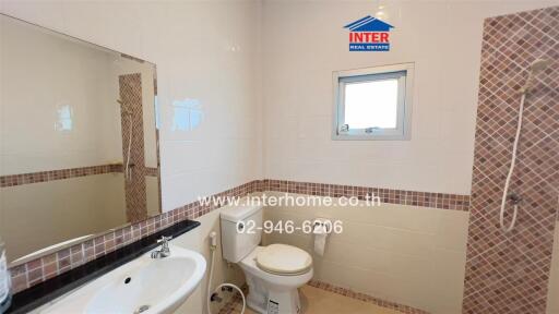 Modern bathroom with a small window, sink, toilet, and shower