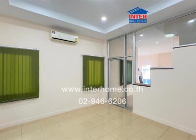 Living room with tiled floor, air conditioning, and large window