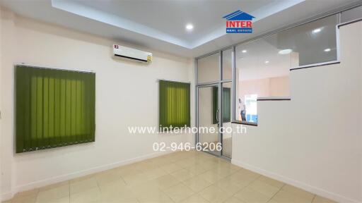 Living room with tiled floor, air conditioning, and large window