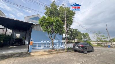 House exterior with driveway and parked cars