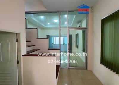 Staircase and small hallway with window and glass door