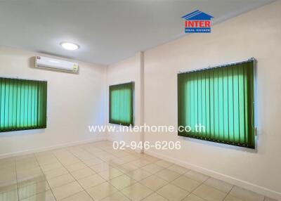 Empty room with tiled flooring, green blinds, and air conditioning