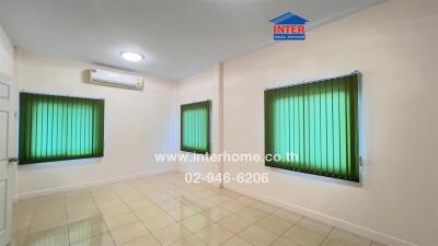 Empty room with tiled flooring, green blinds, and air conditioning