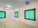 Empty room with tiled flooring, green blinds, and air conditioning