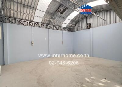 Unfurnished building interior with high ceiling