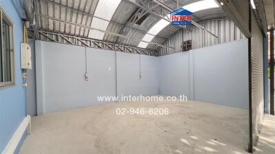 Unfurnished building interior with high ceiling