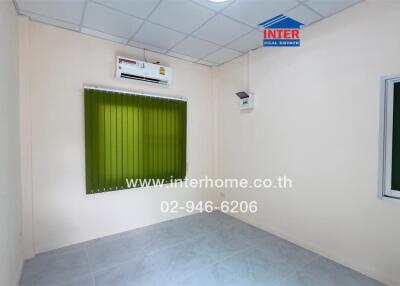 Empty bedroom with air conditioning and green blinds