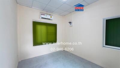 Empty bedroom with air conditioning and green blinds