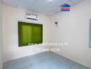 Empty bedroom with air conditioning and green blinds