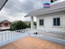 Photo of the outside of a residential building with a balcony