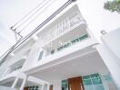 Modern white multi-storey building with balconies