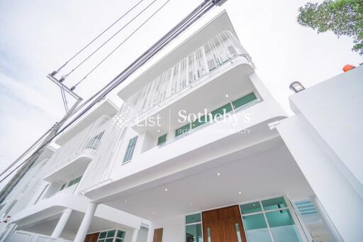 Modern white multi-storey building with balconies