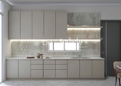 Modern kitchen with beige cabinetry and marble backsplash