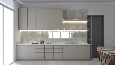 Modern kitchen with beige cabinetry and marble backsplash