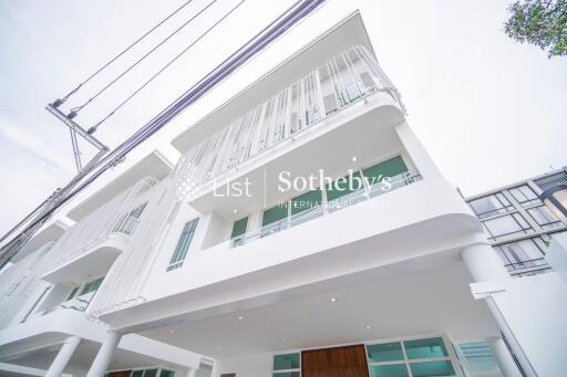 Modern three-story building exterior view with balconies