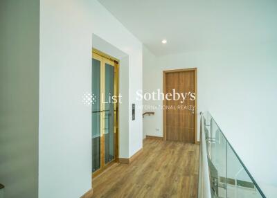 Modern hallway with elevator and wooden floor